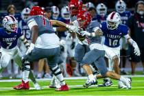 Arbor View wide receiver Jayden Williams (6) gets past Liberty defensive back (10) for more yar ...