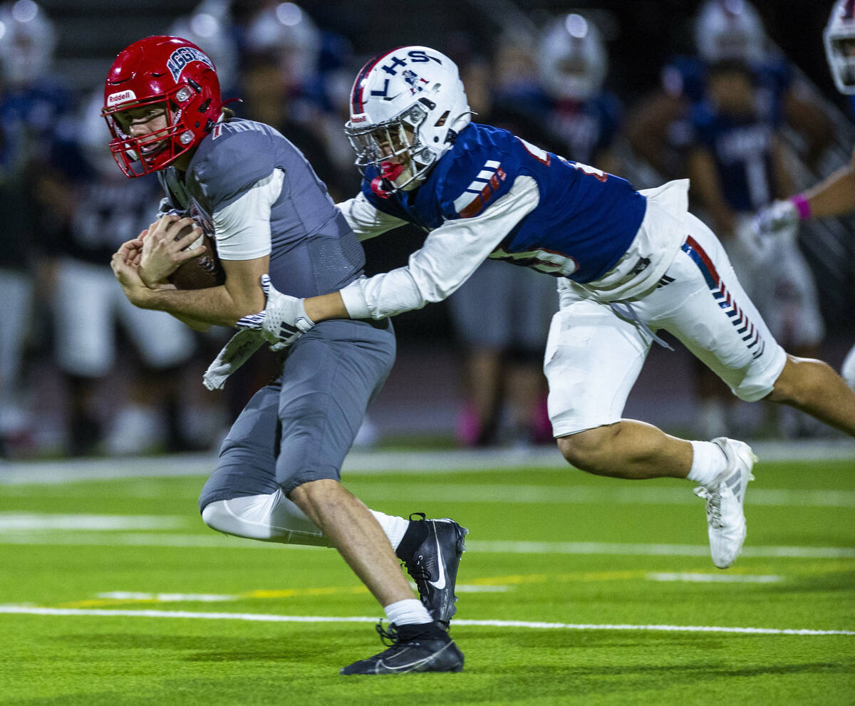 Arbor View quarterback Thaddeus Thatcher (7) is caught by Liberty defensive back Rysen Dacosin- ...