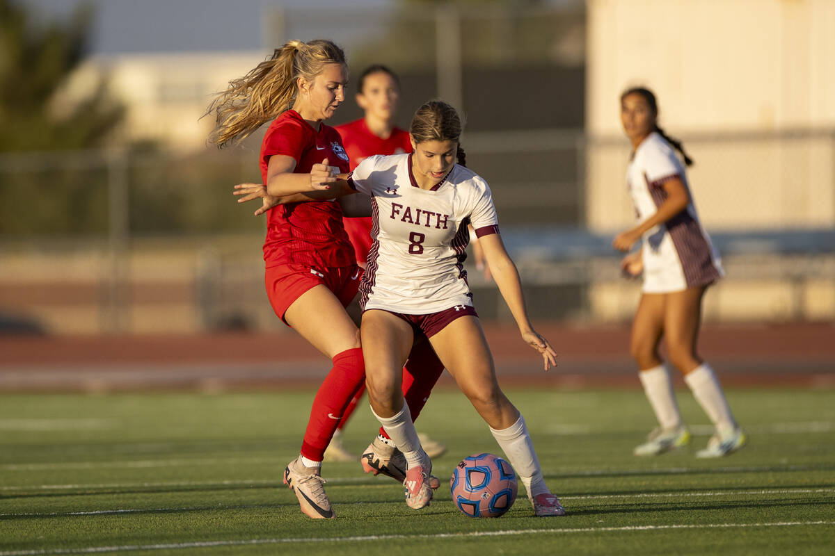 Faith Lutheran forward Olivia Stark (8) attempts to keep the ball from Coronado midfielder Alex ...