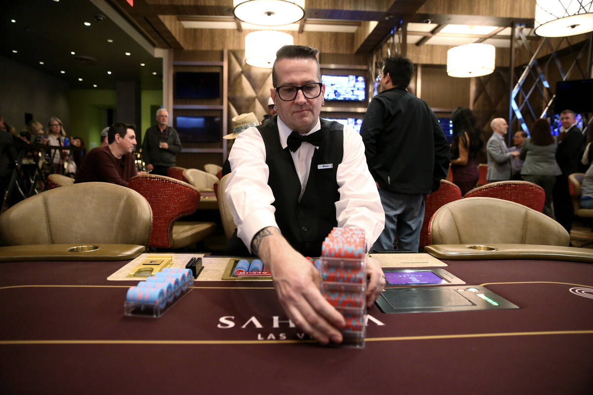 Poker dealer Brett Smith handles stacks of chips during the grand opening for the new poker roo ...