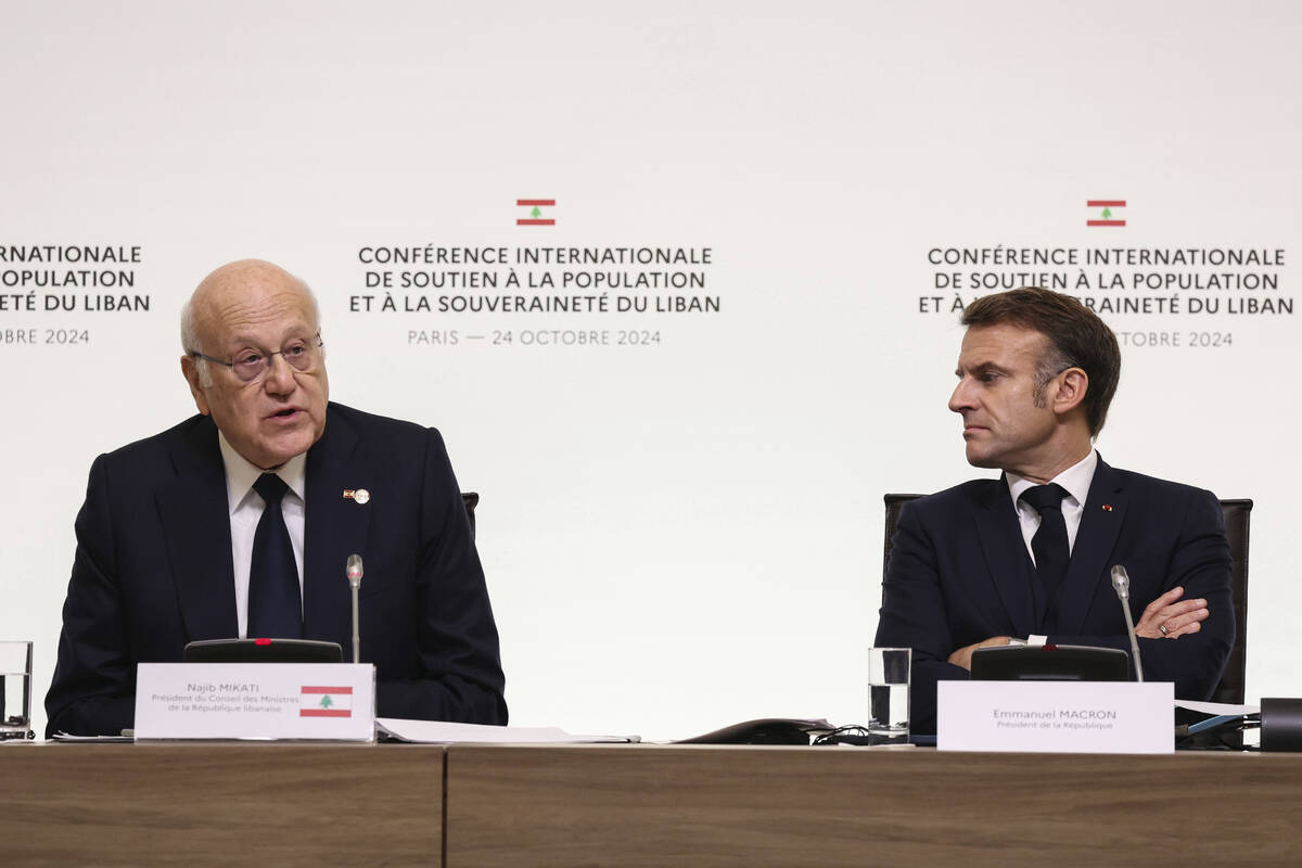 France's President Emmanuel Macron listens to Lebanon's Prime Minister caretaker Prime Minister ...