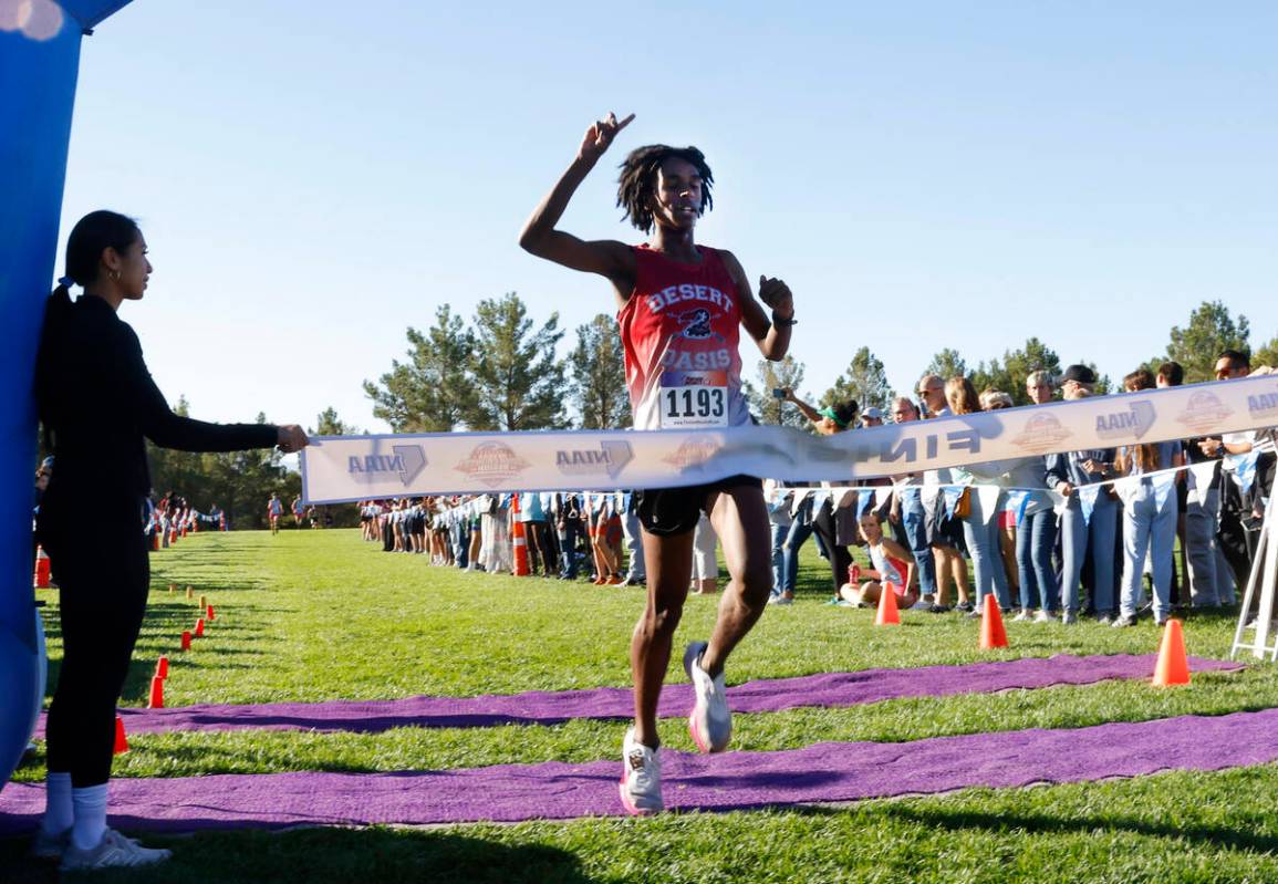 Kenan Dagge of Desert Oasis crosses the finish line during the 5A Southern Region boys cross co ...