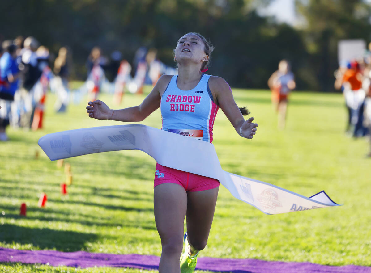 Elynn Okuda of Shadow Ridge crosses the finish line during the 5A Southern girls cross country ...