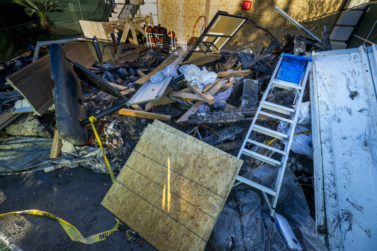 Debris is piled up on the exterior of fatal house fire at 8332 Langhorne Creek Street on Friday ...