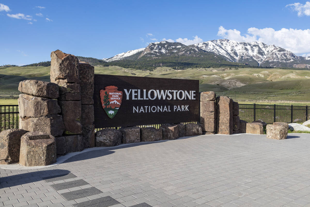 This photo provided by the National Park Service shows a sign marking the entrance of Yellowsto ...