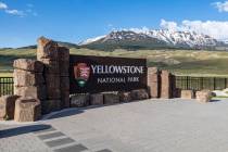 This photo provided by the National Park Service shows a sign marking the entrance of Yellowsto ...