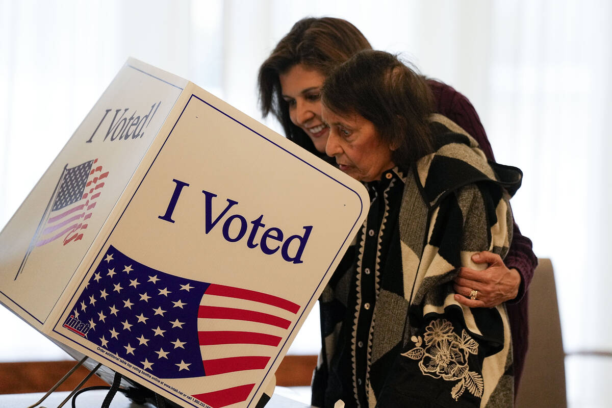 Republican presidential candidate former UN Ambassador Nikki Haley helps her mother Raj Kaur Ra ...