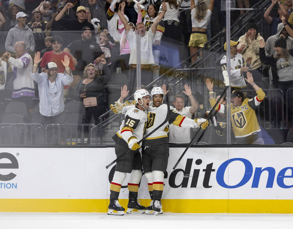 Golden Knights defenseman Noah Hanifin (15) and right wing Keegan Kolesar (55) celebrate a goal ...