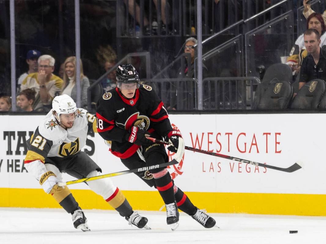 Golden Knights center Brett Howden (21) and Ottawa Senators center Tim Stützle (18) fight ...