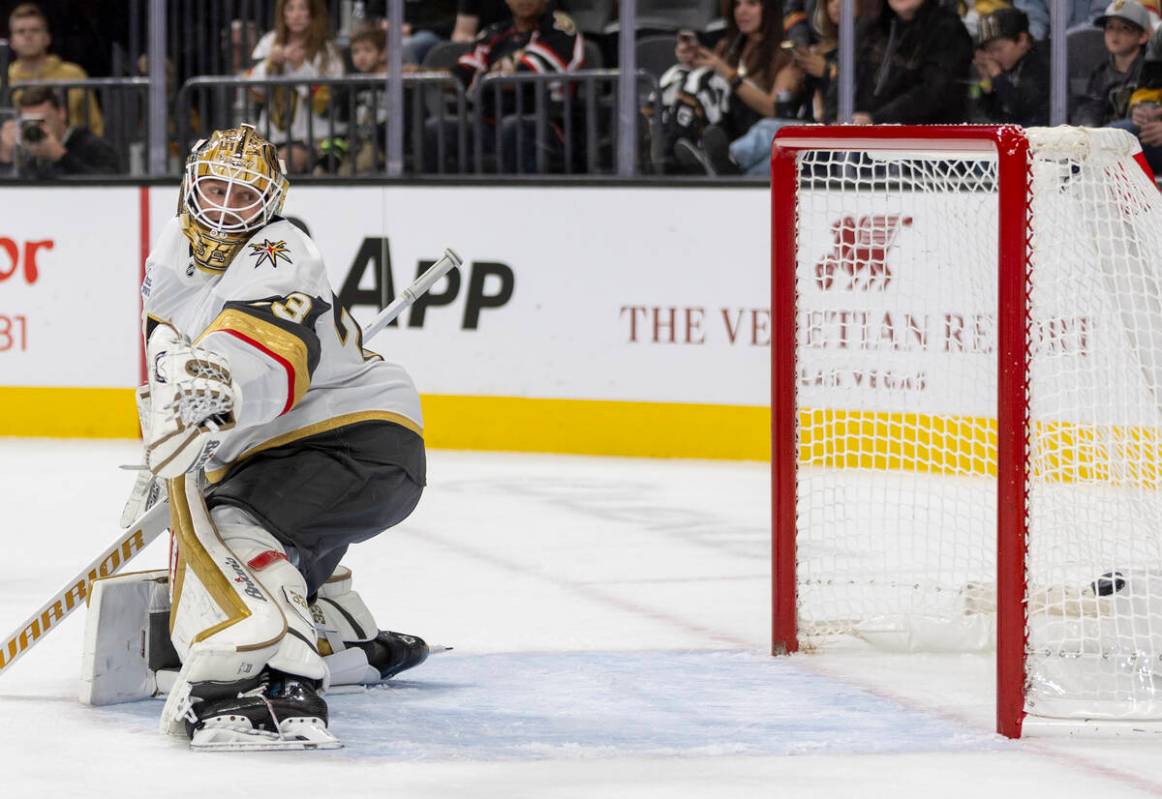 Golden Knights goaltender Adin Hill (33) watches a puck land in the net during the NHL hockey g ...