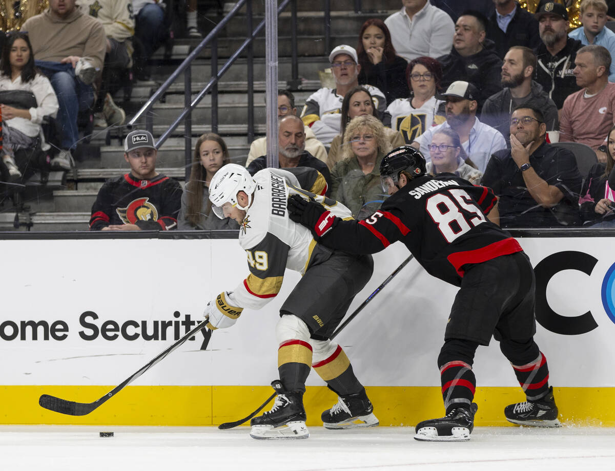 Golden Knights center Ivan Barbashev (49) and Ottawa Senators defenseman Jake Sanderson (85) fi ...