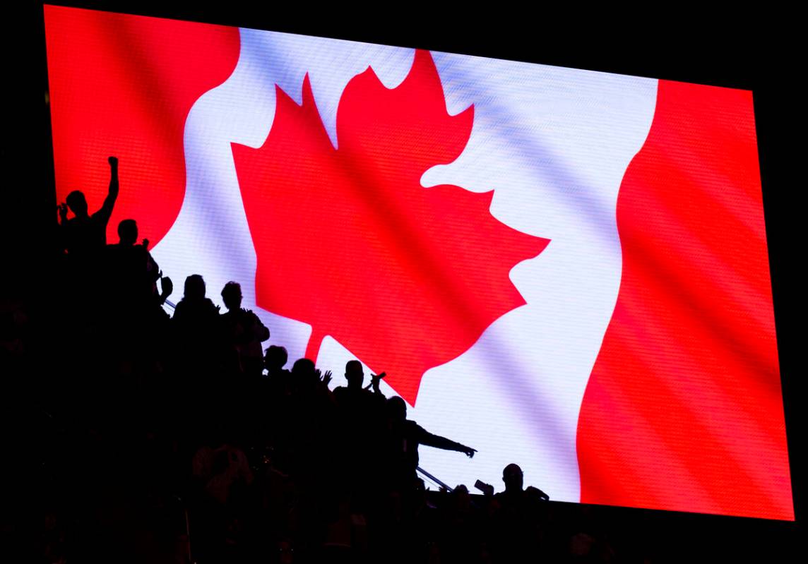 Fans cheer after the singing of the Canadian national anthem before the NHL hockey game between ...