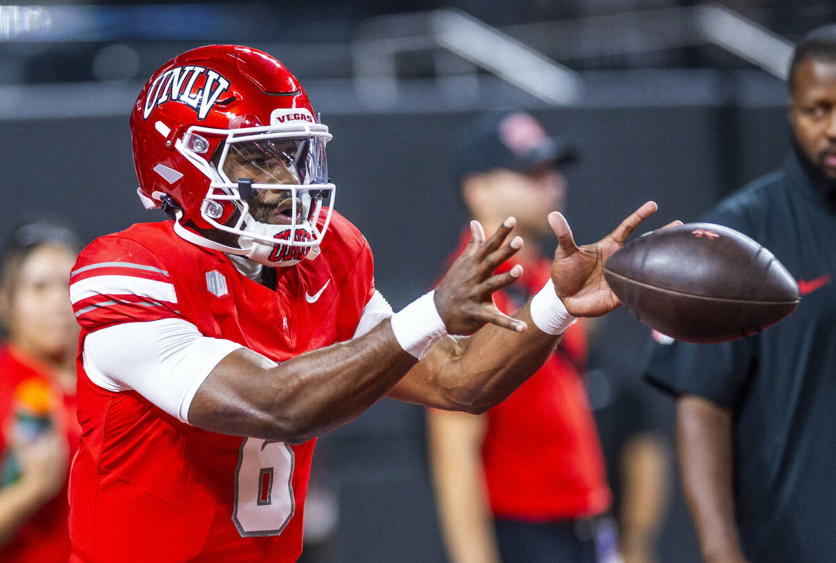 UNLV quarterback Hajj-Malik Williams (6) receives a snap during warm ups of their NCAA football ...