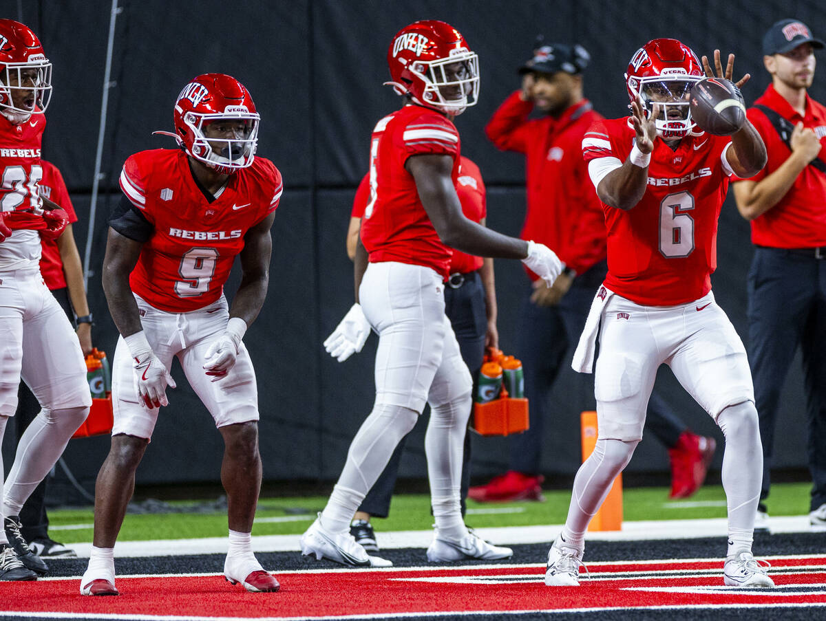 UNLV quarterback Hajj-Malik Williams (6) receives a snap during warm ups of their NCAA football ...