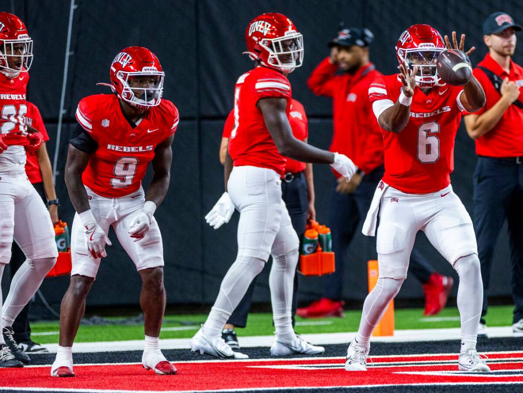 UNLV quarterback Hajj-Malik Williams (6) receives a snap during warm ups of their NCAA football ...