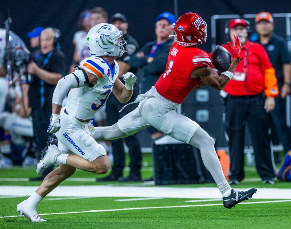 UNLV wide receiver Casey Cain (1) hauls in a long pass over Boise State Broncos safety Alexande ...