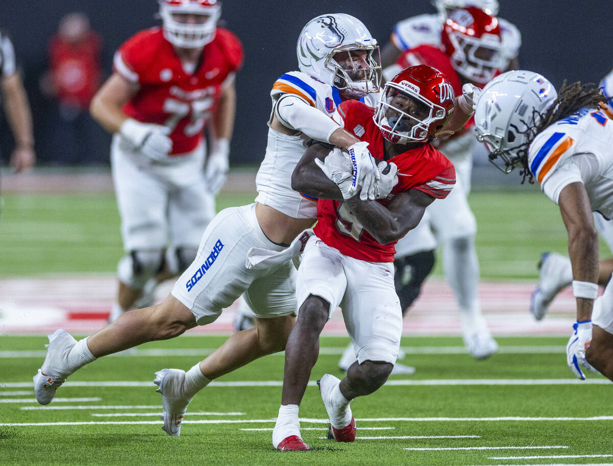 UNLV running back Jai'Den Thomas (9) battles for mare yards against the Boise State Broncos def ...