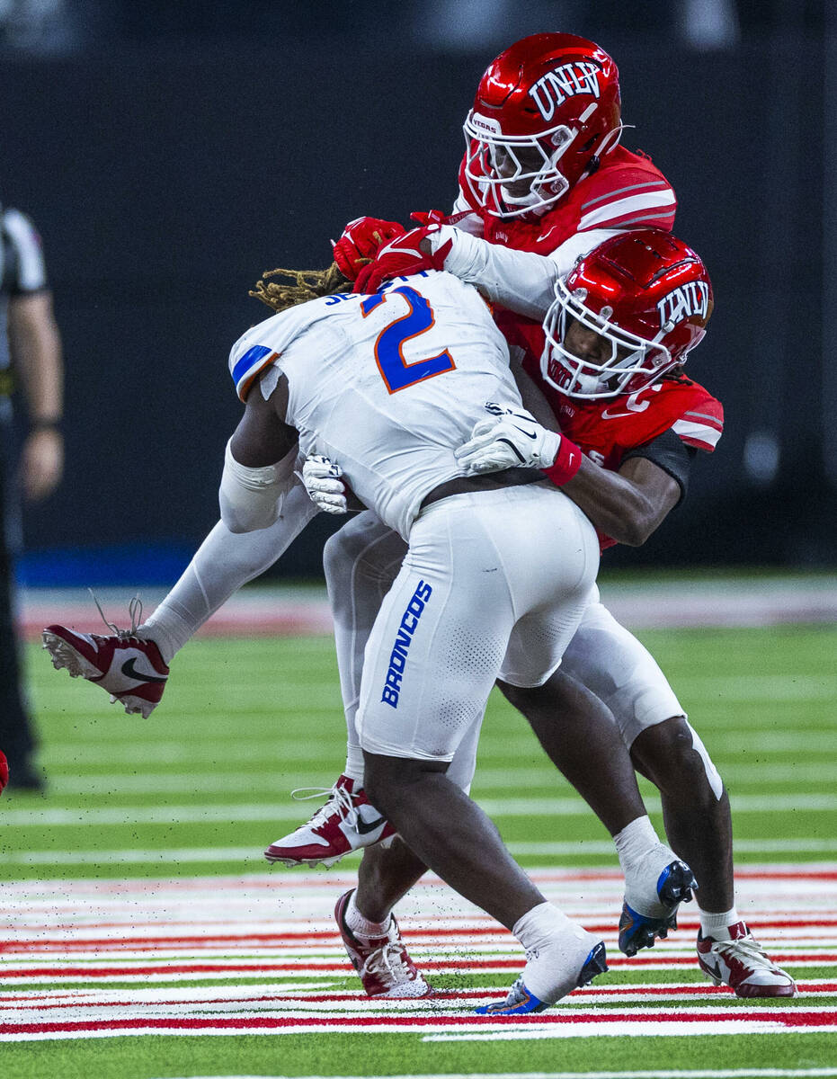 Boise State Broncos running back Ashton Jeanty (2) is double teamed on a tackle by UNLV defende ...