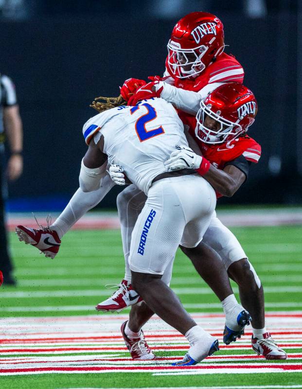 Boise State Broncos running back Ashton Jeanty (2) is double teamed on a tackle by UNLV defende ...