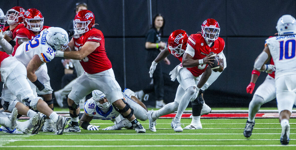 UNLV quarterback Hajj-Malik Williams (6) looks for a receiver but will run again as Boise State ...