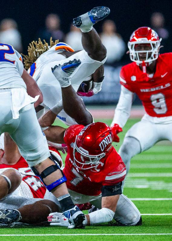 UNLV linebacker Jackson Woodard (7) upends Boise State Broncos running back Ashton Jeanty (2) o ...