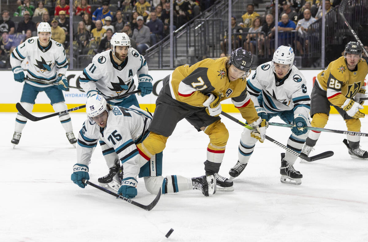 Golden Knights and San Jose Sharks players fight for the puck during the first period of the NH ...