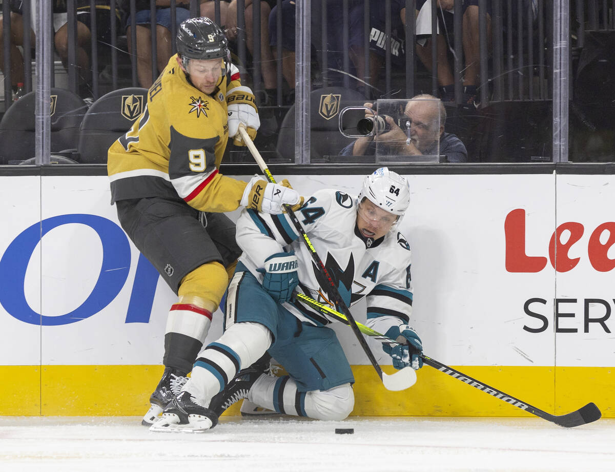 Golden Knights center Jack Eichel (9) and San Jose Sharks center Mikael Granlund (64) fight for ...