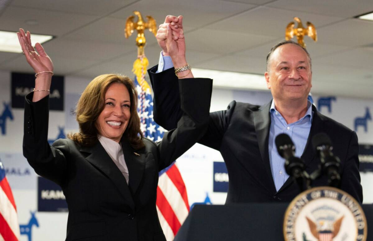 Vice President Kamala Harris, left, and second gentleman Doug Emhoff address staff at her campa ...