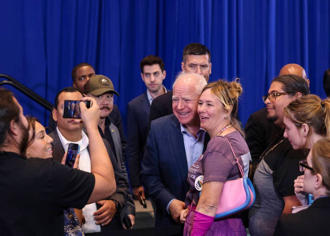 Democratic vice presidential candidate Tim Walz takes a photo with supporters following a &quot ...