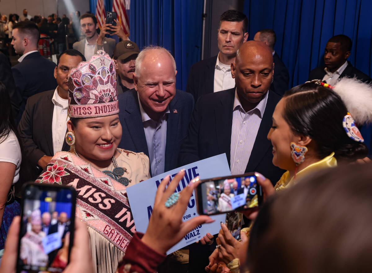 Democratic vice presidential candidate Tim Walz takes a photo with Kassie John, Miss Indian Wor ...