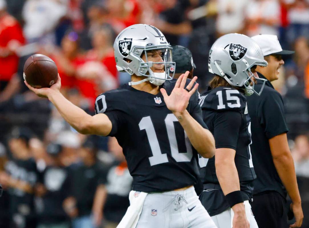 Raiders quarterback Desmond Ridder (10) throws the ball as he warms up prior to an NFL game aga ...