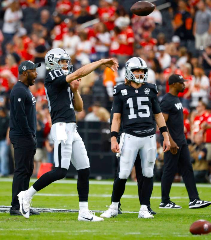 Raiders quarterback Desmond Ridder (10) throws the ball as quarterback Gardner Minshew (15) loo ...