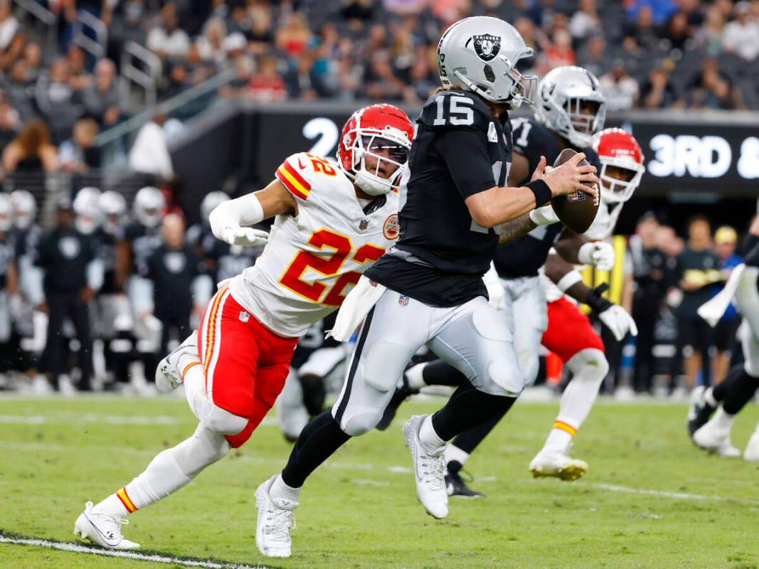 Raiders quarterback Gardner Minshew (15) is chased by Kansas City Chiefs cornerback Trent McDuf ...