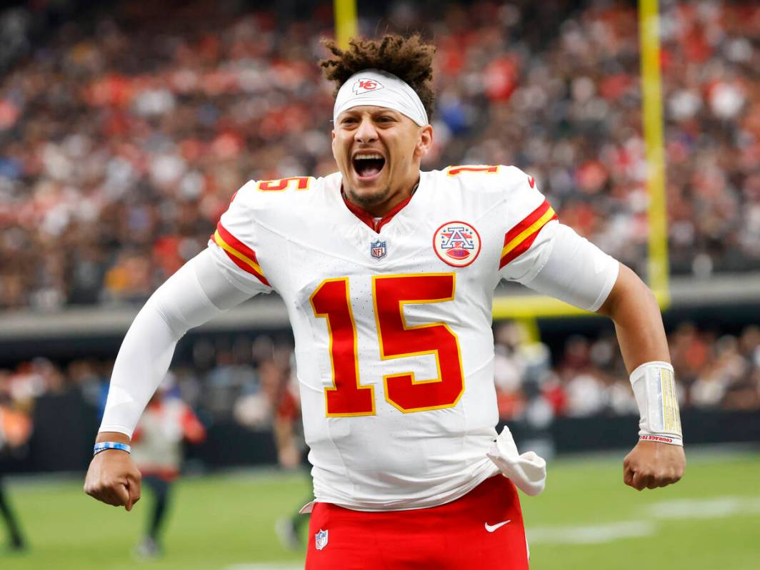 Kansas City Chiefs quarterback Patrick Mahomes (15) pumps up his team before facing Raiders in ...