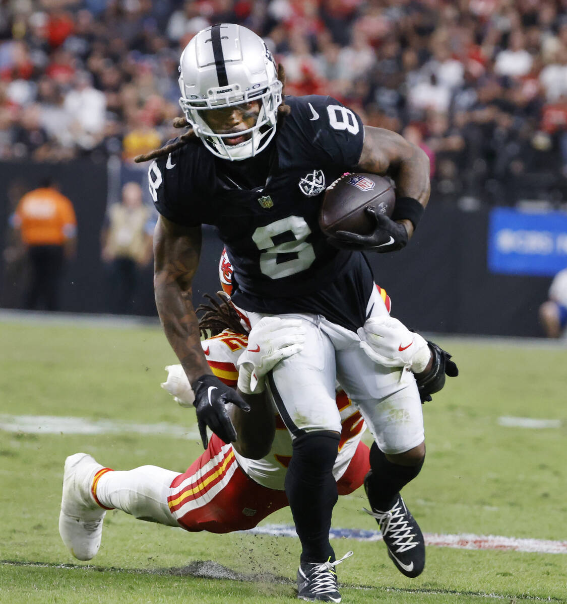 Kansas City Chiefs linebacker Nick Bolton (32) tries to take down Raiders running back Ameer Ab ...