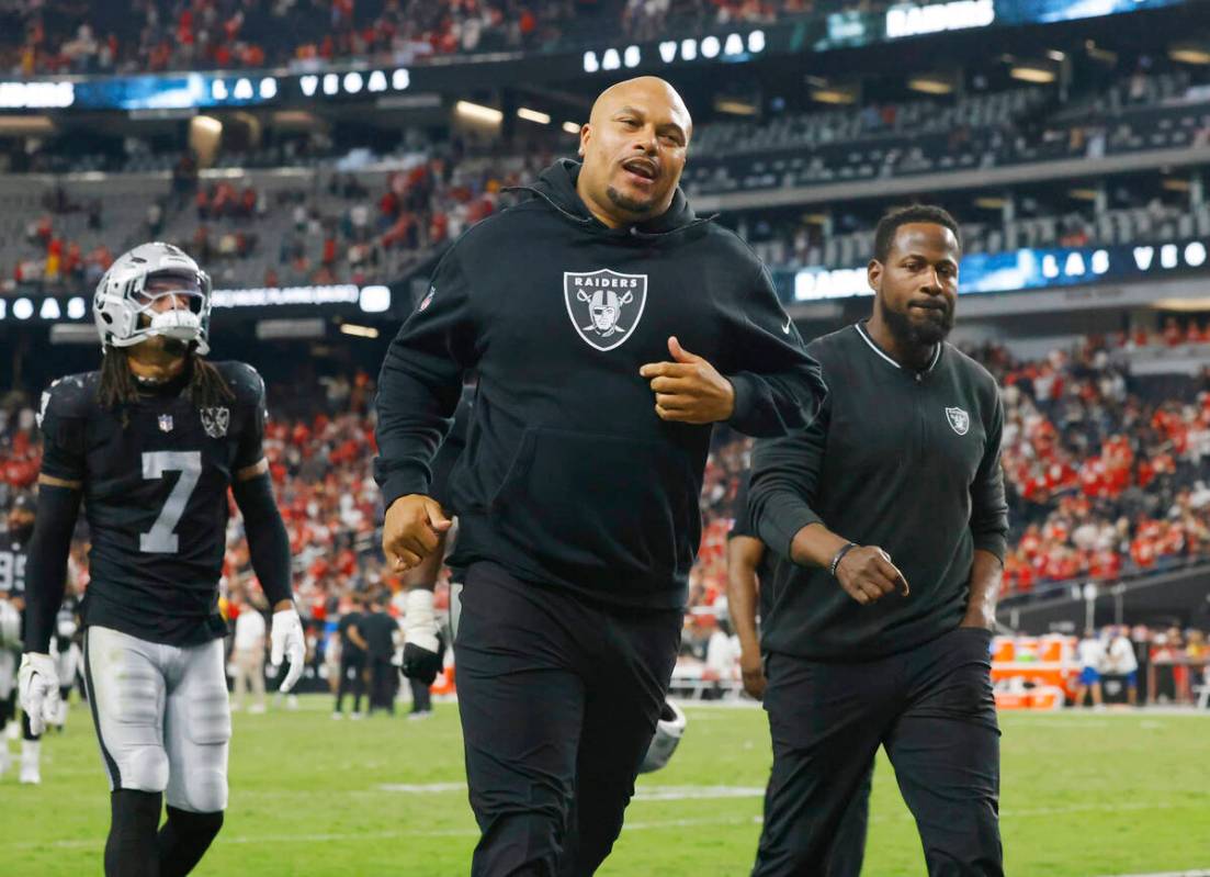 Raiders head coach Antonio Pierce runs off the field after an NFL game against Kansas City Chie ...