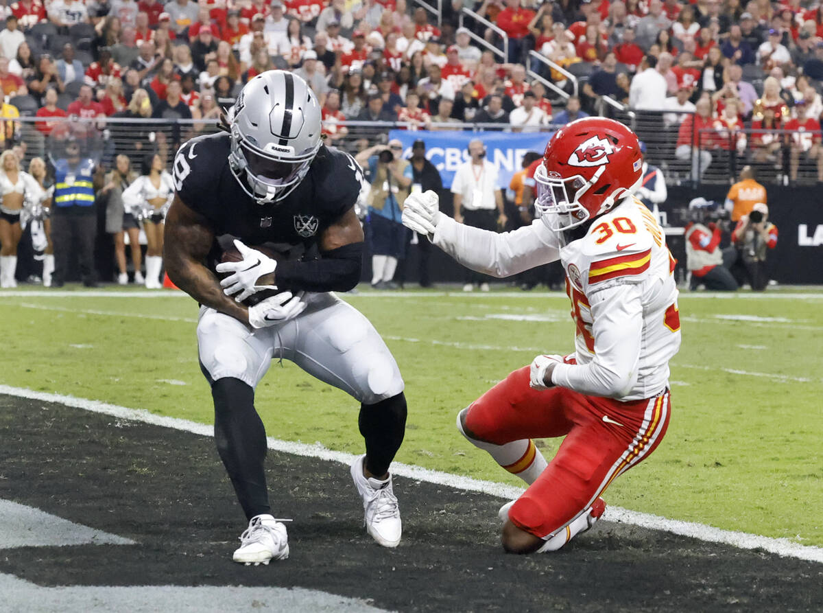 Raiders wide receiver DJ Turner (19) scores a touchdown as Kansas City Chiefs cornerback Christ ...