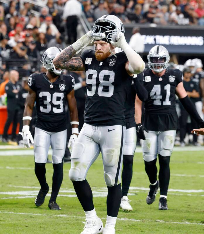 Raiders defensive end Maxx Crosby (98) puts his helmet on as he takes the field during the seco ...