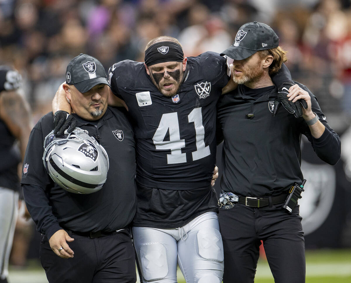 Raiders linebacker Robert Spillane (41) is helped off the field during the first half of the NF ...