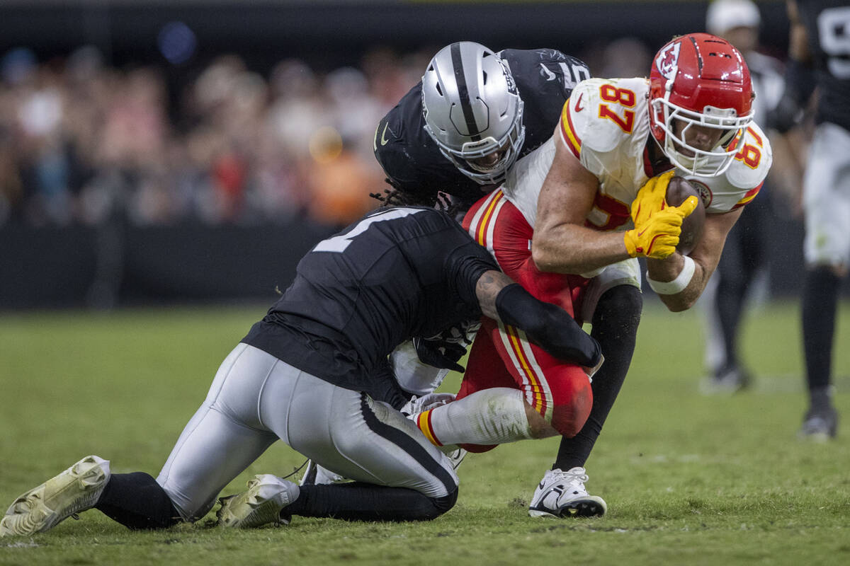 Raiders linebacker Divine Deablo (5) and safety Tre'von Moehrig (7) tackle Kansas City Chiefs t ...