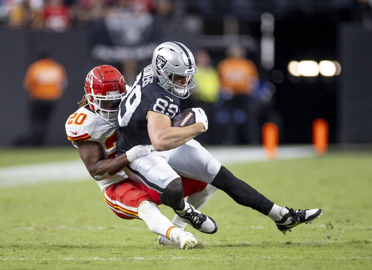 Raiders tight end Brock Bowers (89) is tackled by Kansas City Chiefs safety Justin Reid (20) du ...