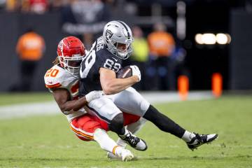 Raiders tight end Brock Bowers (89) is tackled by Kansas City Chiefs safety Justin Reid (20) du ...