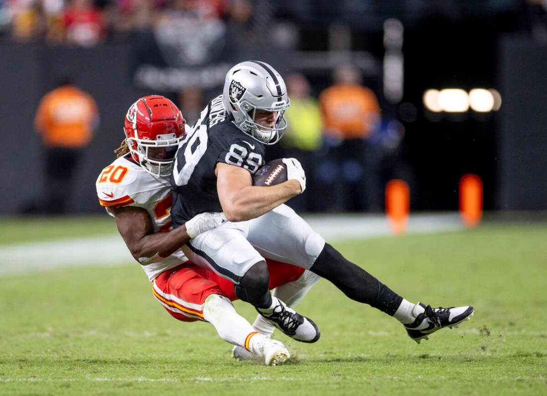 Raiders tight end Brock Bowers (89) is tackled by Kansas City Chiefs safety Justin Reid (20) du ...