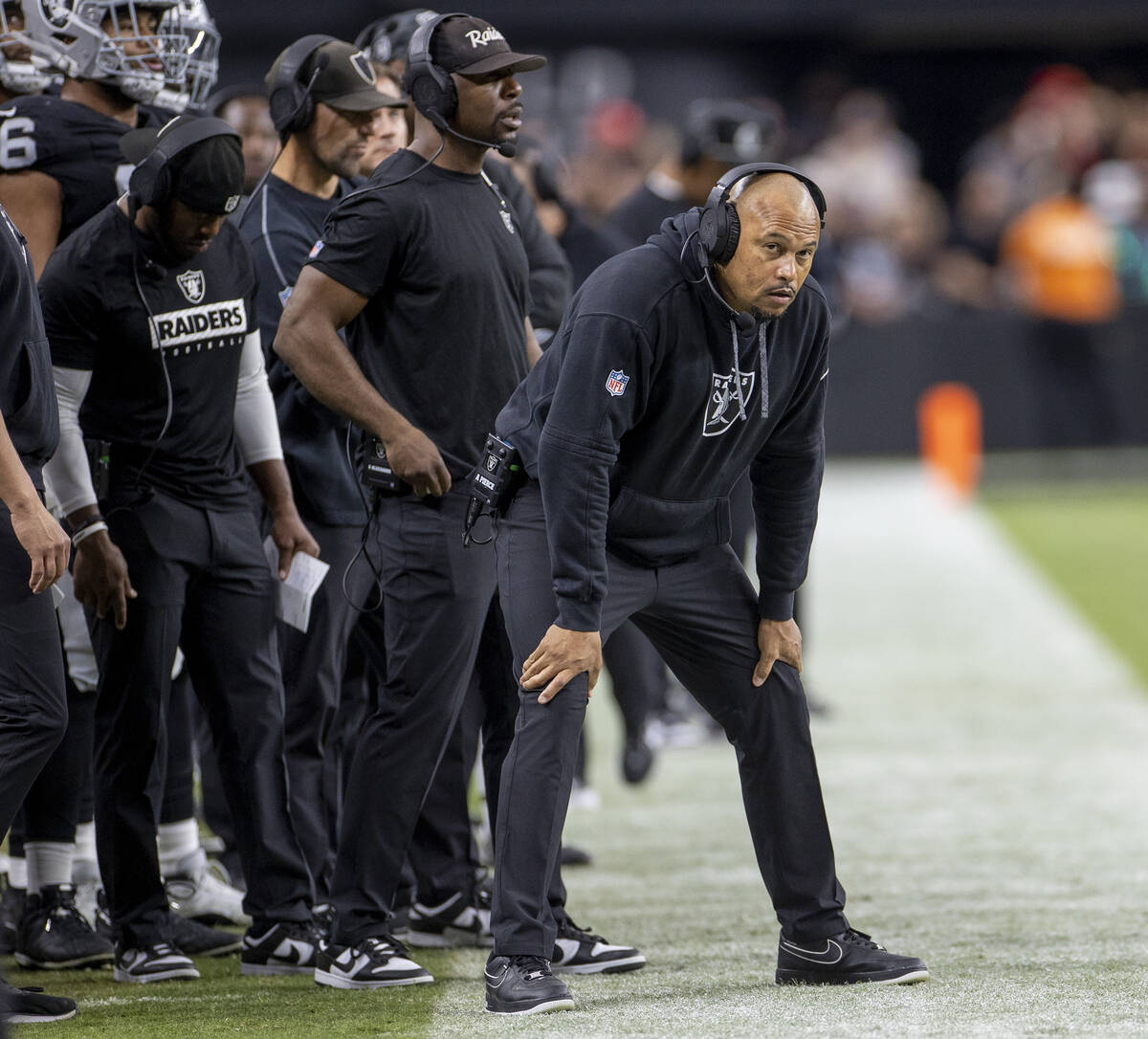 Raiders Head Coach Antonio Pierce watches a big screen during the first half of the NFL footbal ...