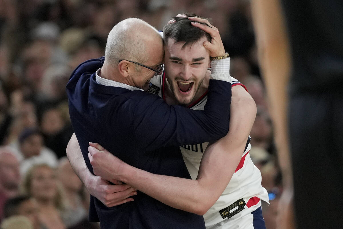 FILE - UConn head coach Dan Hurley celebrates with forward Alex Karaban (11) after their win ag ...