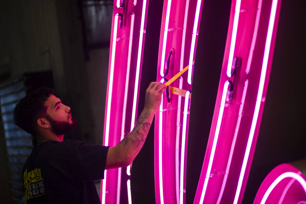 A YESCO employee checks the “Debbie” neon sign, from the former Debbie Reynolds H ...