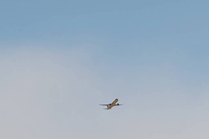 With a dust cloud east of Harry Reid International Airport, a jetliner takes off in Las Vegas o ...