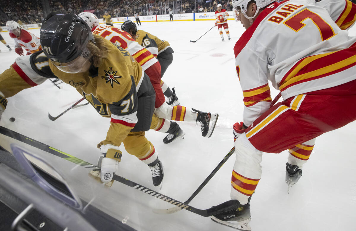 Golden Knights center William Karlsson (71) battles for the puck against Calgary Flames defense ...