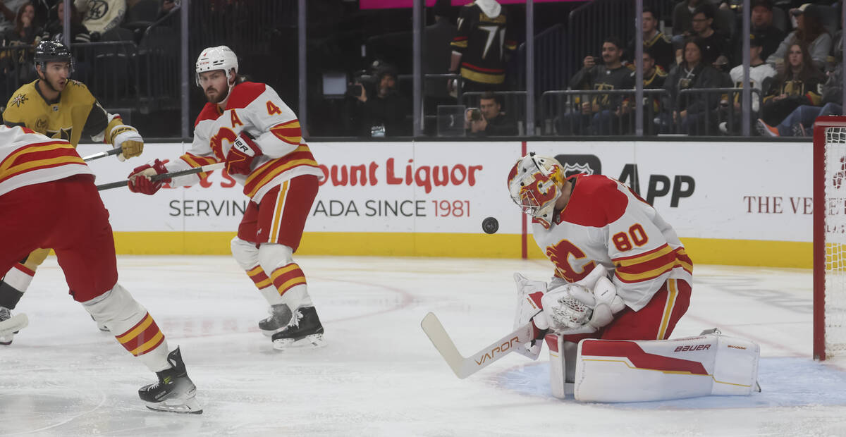 Calgary Flames goaltender Dan Vladar (80) stops a shot from the Golden Knights during the first ...