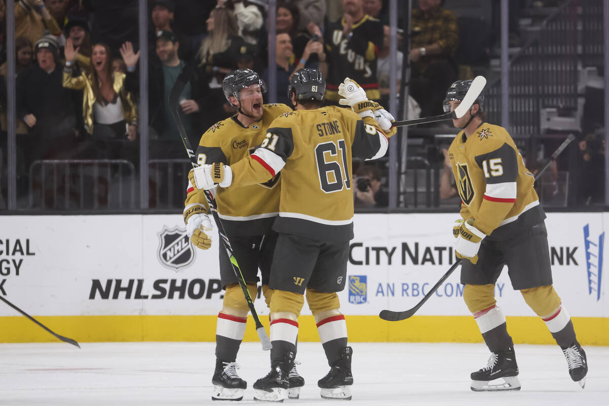 Golden Knights right wing Mark Stone (61) celebrates his goal with Golden Knights center Jack E ...